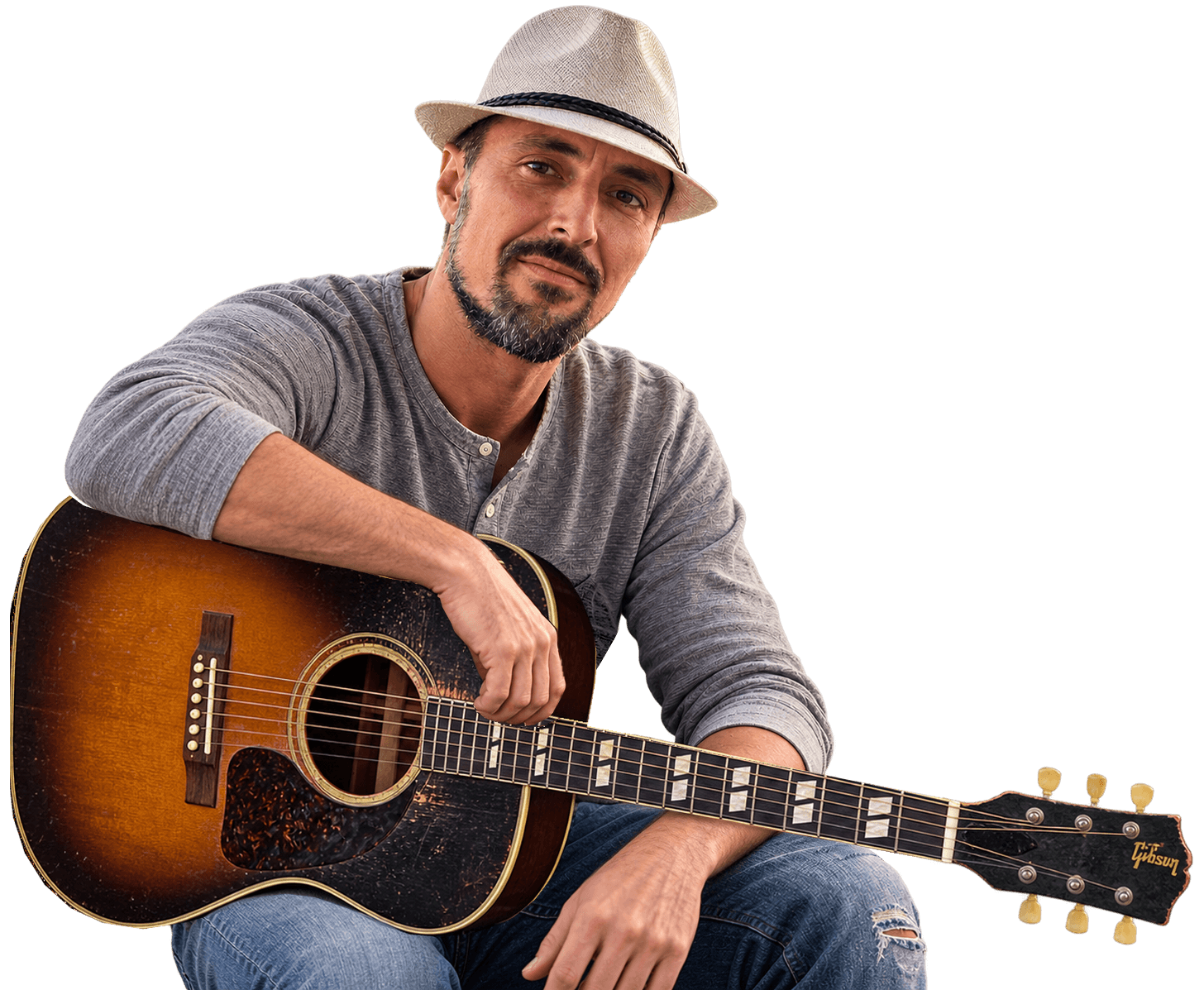 Chris Cash seated with his Gibson acoustic guitar